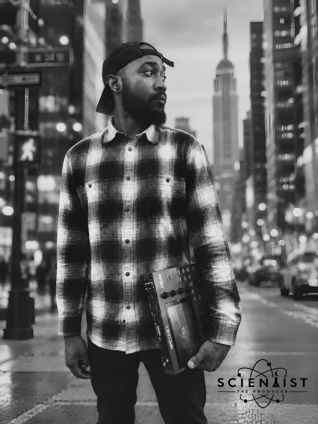 SCIENTIST on a New York City street, an MPC under his arm, the Empire State Building behind him; his SCIENTIST The Producer logo in the corner